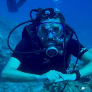 A diver with scuba gear underwater. - CertiDive